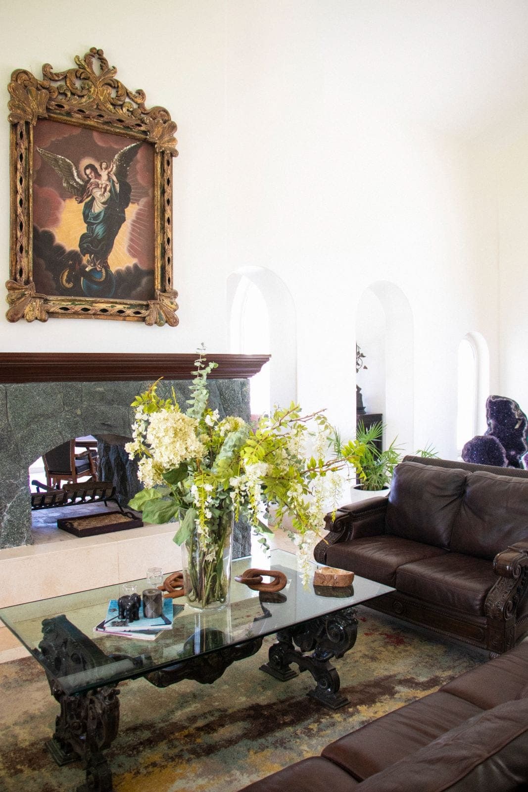 Main hall with stone fireplace and antique art collection