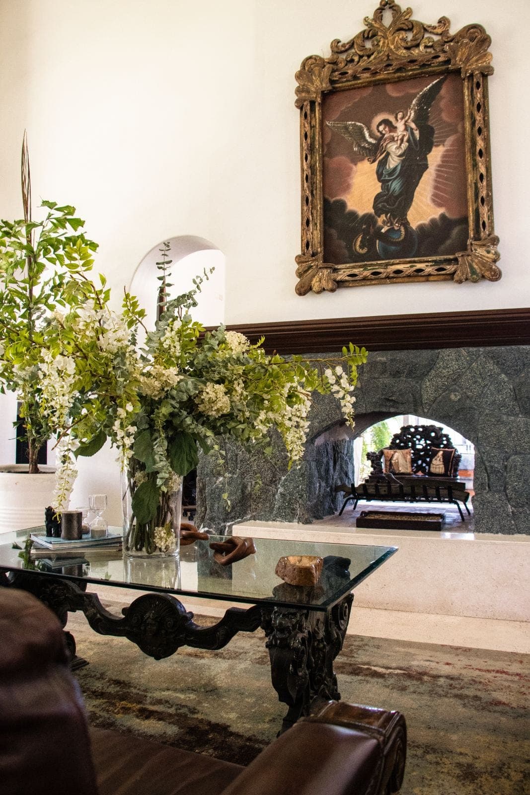 Stone fireplace and antique gold-framed oil painting